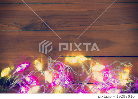 Christmas light on the wooden background 19292010