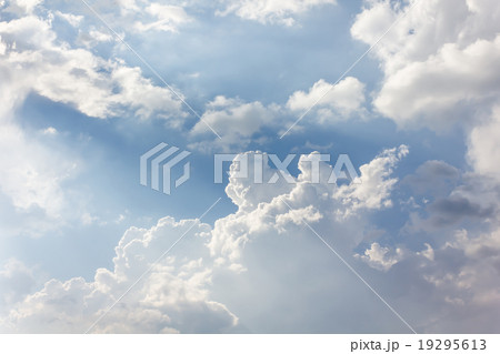 Beautiful light blue sky with puffy white clouds Beautiful light blue sky with puffy white clouds 19295613