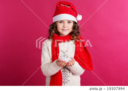 Little girl is holding fake snow in hands Little girl is holding fake snow in hands 19307994