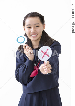 バツのマークを差し出す女子中学生 19309334