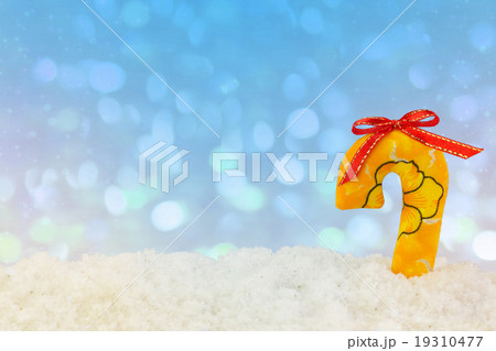 Fabric cane stick on snow with abstract background Fabric cane stick on snow with abstract background 19310477