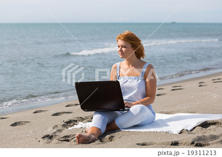 redheaded girl working at a laptop sitting on the redheaded girl working at a laptop sitting on the 19311213