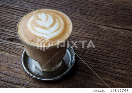 A cup of Latte art coffee on wooden table A cup of Latte art coffee on wooden table 19315748