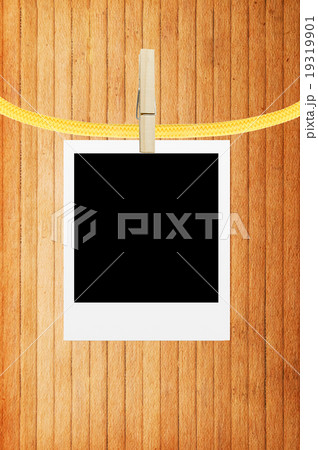 photo frame with clothespin over wooden background 19319901