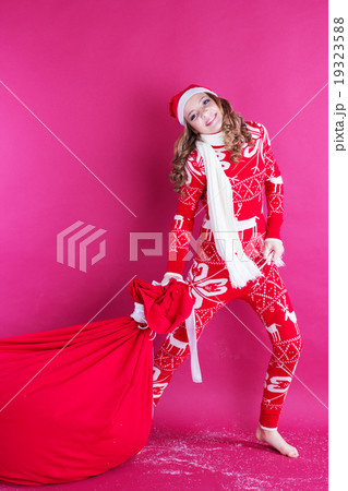 Santa girl is holding big red christmas bag Santa girl is holding big red christmas bag 19323588