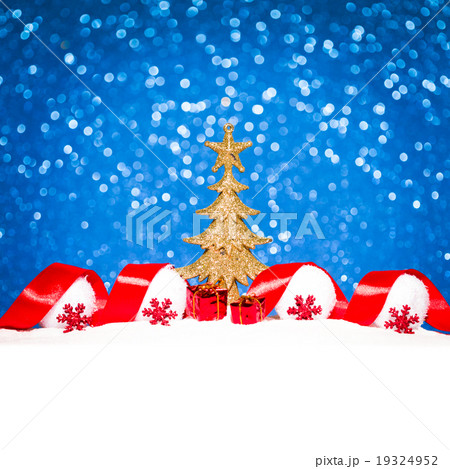 Golden Christmas tree on glitter blue backgroundの写真素材