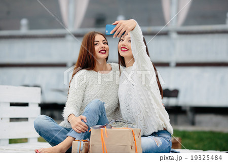Two girls make selfie with gifts 19325484