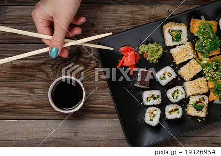 Sushi. Hand with chopsticks Sushi. Hand with chopsticks 19326954