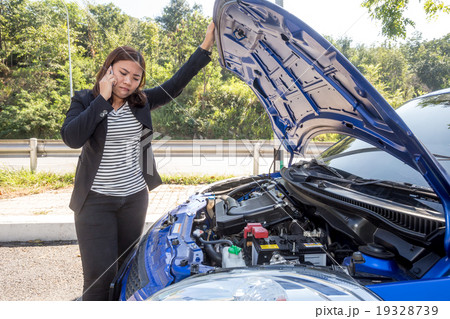 Asian women calling after breaking down car Asian women calling after breaking down car 19328739