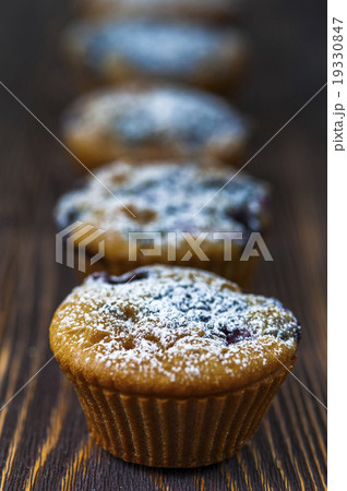 Muffins with black currants standing in a row Muffins with black currants standing in a row 19330847