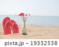 Red old slippers and flower on the beach 19332538