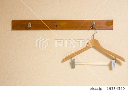 clothing hanger on the brown wooden wall clothing hanger on the brown wooden wall 19334540