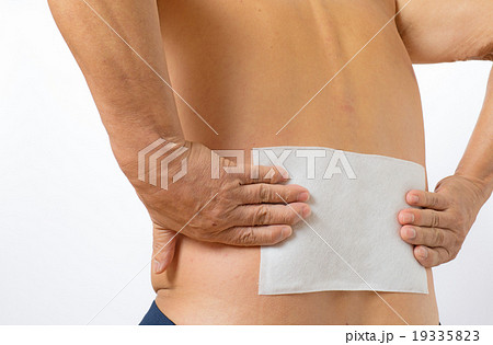 腰に湿布薬を貼っているシニア 19335823
