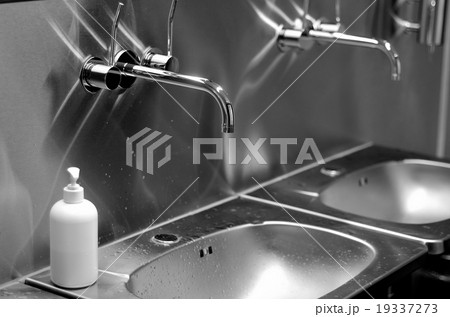 faucets, sinks and liquid soap in a toilet faucets, sinks and liquid soap in a toilet 19337273