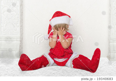 Little child in Santa suit sitting on floor with snow 19340683