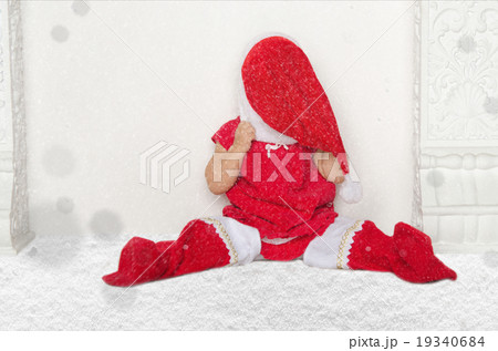 Small girl in Santa suit sitting on floor with snow Small girl in Santa suit sitting on floor with snow 19340684
