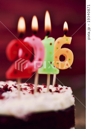 lit number-shaped candles forming 2016 on a cake lit number-shaped candles forming 2016 on a cake 19340871