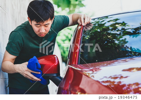 Young Asian man washing a car in outdoor 19346475