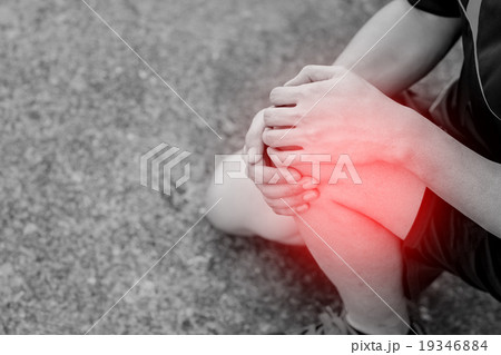 Runner touching painful knee. training accident. 19346884