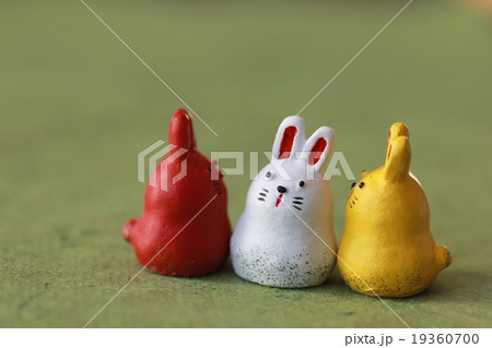 和紙の上に置いた赤白黄色のうさぎの置物　卯年 19360700