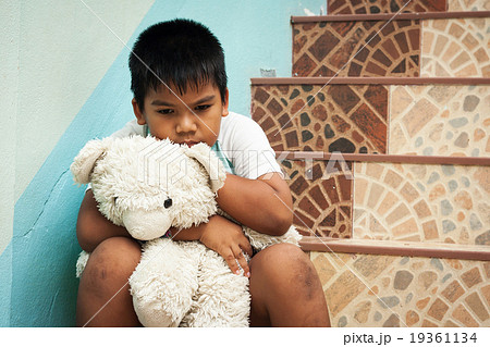 little boy sitting alone at staircase in the park 19361134