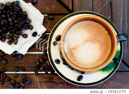 Cup of coffee, cappuccino with beans and a book. 19362279