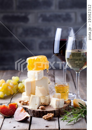 Grape, cheese, figs and honey with a glasses wine. Grape, cheese, figs and honey with a glasses wine. 19362312