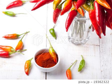 Chili peppers on a white wooden background 19362322