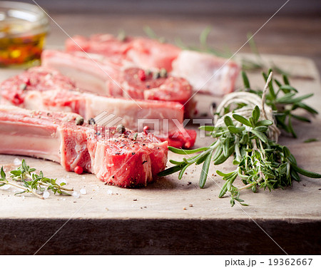 Raw meat, mutton, lamb rack on a wooden background Raw meat, mutton, lamb rack on a wooden background 19362667