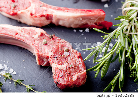 Raw meat, mutton, lamb rack with fresh herbs. Raw meat, mutton, lamb rack with fresh herbs. 19362838