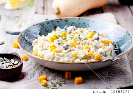 Pumpkin, blue cheese risotto in a ceramic plate 19363172