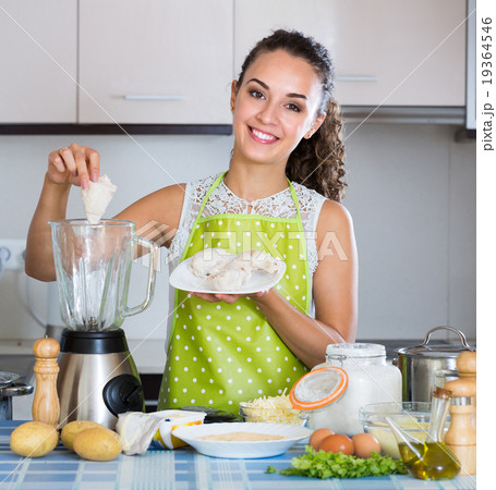 Woman with blender at kitchen. 19364546