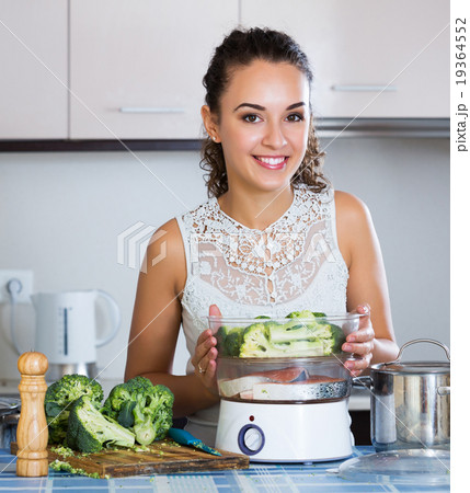 Girl preparing fish and veggies 19364552