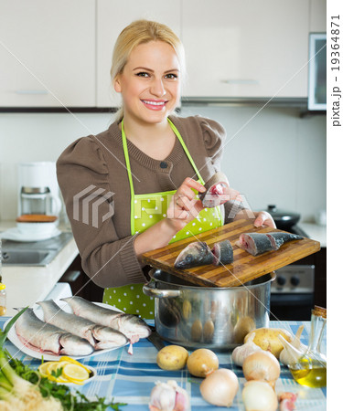 Female standing near boiling pan Female standing near boiling pan 19364871