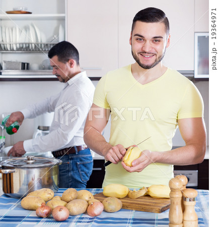 men cooking potato soup 19364971