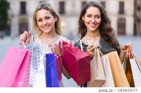 Girls with shopping bags at street. Girls with shopping bags at street. 19365077
