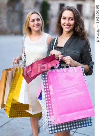 Girls with shopping bags at street. Girls with shopping bags at street. 19365099
