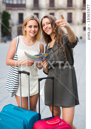 Two girls with luggage at street. Two girls with luggage at street. 19365977