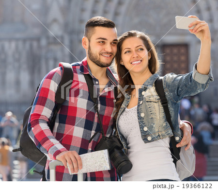 Couple with luggage doing selfie Couple with luggage doing selfie 19366122