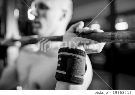 Athletes preparing for barbell exercises 19368512