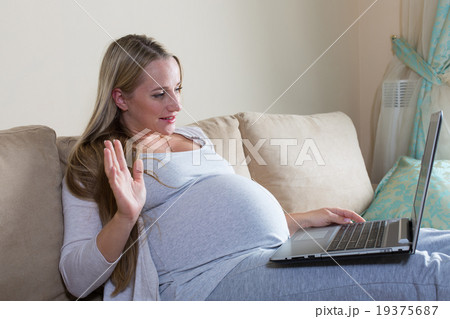 pregnant woman spends time a laptop 19375687