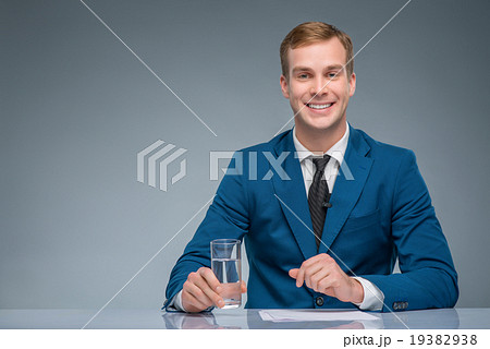 Smiling newscaster during broadcasting.  19382938
