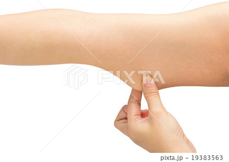 Woman testing the flabby muscle under her arm Woman testing the flabby muscle under her arm 19383563