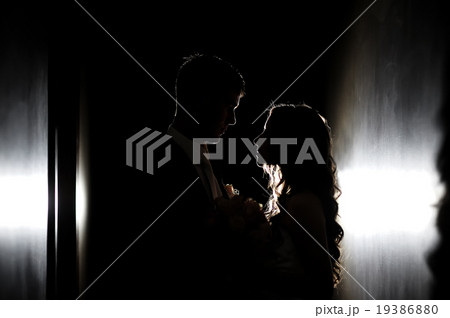 silhouette of the bride and groom at a wedding 19386880