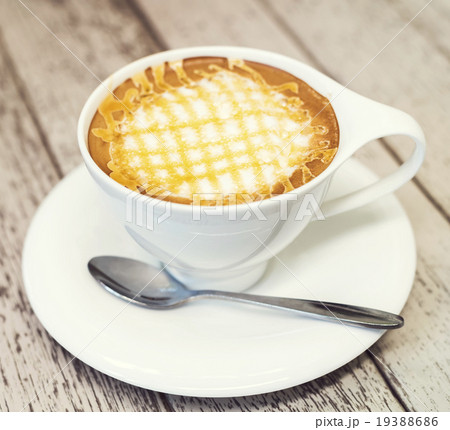 Cappuccino coffee in white cup on wood background. 19388686
