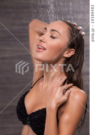 Cheerful young woman is washing in bathroom Cheerful young woman is washing in bathroom 19389483