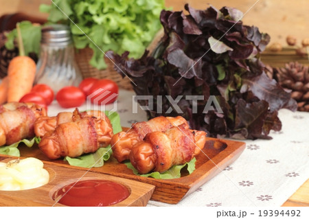 Grilled sausages wrapped in bacon fat delicious. Grilled sausages wrapped in bacon fat delicious. 19394492
