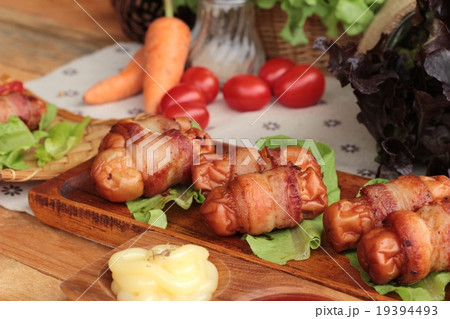 Grilled sausages wrapped in bacon fat delicious. Grilled sausages wrapped in bacon fat delicious. 19394493