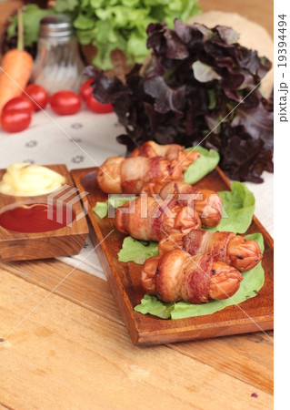 Grilled sausages wrapped in bacon fat delicious. 19394494