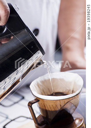 Pouring hot water to Fresh coffee on paper filter Pouring hot water to Fresh coffee on paper filter 19398245